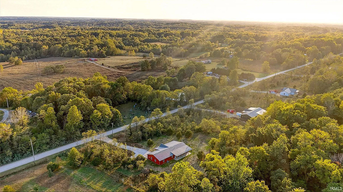 Aerial view of land and various properties.