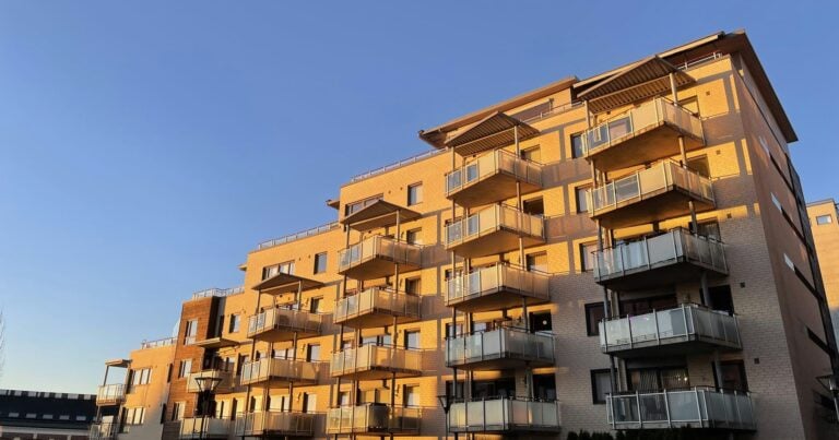 Multifamily apartment building with balconies at golden hour, a typical real estate syndication property